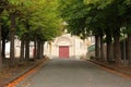 View of the church through an avenue of trees in Gorron Royalty Free Stock Photo