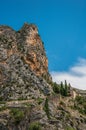 View of the church Notre-Dame de Beauvoir amid the cliffs and steeple of Moustiers-Sainte-Marie. Royalty Free Stock Photo