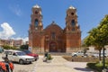 View of the church of Nuestra SeÃ±ora de las Mercedes, view of some tourists and parked cars at noon, located in Carhuaz