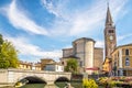 View at the Church of Saint Andrew with bridge over Lemene river in Portogruaro, Italy