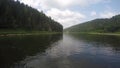 View of chusovaya river from sailing catamaran. POV. Green bacnk of river on both sides.