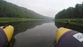 View of chusovaya river from sailing catamaran. POV. Green bacnk of river on both sides.