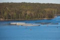 View of circle sea fish farm cages and round fishing nets, farming salmon, trout and cod, feeding the fish a forage, with Royalty Free Stock Photo