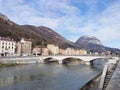 Footbridge over river by buildings in Grenoble France