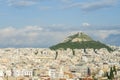 View of the city of Athens, and a large mountain with a monastery on top. Beautiful blue sky Royalty Free Stock Photo