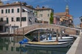View of the city of Chioggia with wooden boats and bridge over canal, little Venice Italy Royalty Free Stock Photo