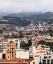 View of the city of funchal in madeira with old church and houses with road bridge and mountains in the distance Royalty Free Stock Photo