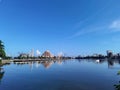 a view of a city with a large building in the background and blue sky