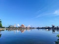 a view of a city with a large building in the background and blue sky