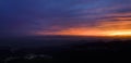 View of city lights from mountain top during sunset Royalty Free Stock Photo