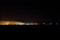 View on city lights at night. Smoke from chimneys of the factory rises to sky. Environmental pollution concept Royalty Free Stock Photo