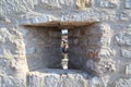 View of the city through the loophole of a medieval fortress Royalty Free Stock Photo