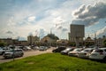 View of the city main railway station from the Abalakov Brothers Street with many parked private cars in the foreground on a