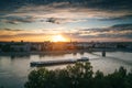 View of the city of Novi Sad and Danube river Strand bridge at sunset from the Petrovaradin fortress. A barge floats on the river Royalty Free Stock Photo