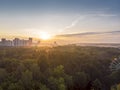 View of city from the park at sunrise time. golden rising sun in