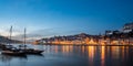 View of the city of poto at night with classic rabelo boat