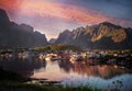 View of the city of Reine on the Lofoten islands, a beautiful bright landscape, white and red houses on a background of rocks at