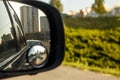 view of the city in the right side car mirror in the evening at sunset. Royalty Free Stock Photo