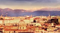 View of the city at sunset. On the horizon tops of mountains in the snow. Rome.