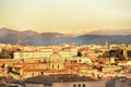 View of the city at sunset. On the horizon tops of mountains in the snow. Rome.