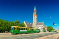 View of a city tram in Helsinki and the old historical building of The National Museum of Finland