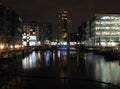 Cityscape view of clarence dock in leeds at night with waterside buildings and lights reflected in the water