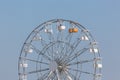 View of a classic giant ferris wheel with chairs, metallic structure, recreational park and festival element