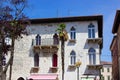 View of a classical colorful croatian house with some palmtrees at the foreground, in the old town of Porec also called Parenzo