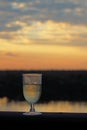 A GLASS OF WINE WITH AN AFRICAN SUNSET IN THE BACKGROUND Royalty Free Stock Photo