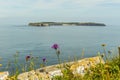 A view from the cliff edge at Lydstep, Wales across the bay to Caldey island home to Cistercian Monks Royalty Free Stock Photo