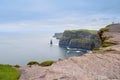 View on Cliff of Moher, county Clare, Ireland.Silhoette of couple of tourists. Epic landscape with magnificent scenery. Irish Royalty Free Stock Photo