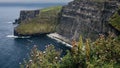 view of the Cliffs of Moher in Ireland with rugged coastline and cloudy sky Royalty Free Stock Photo