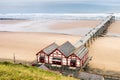 View from the cliffs of Saltburn Pier in North Yorkshire with its Victorian ironwork structure, sandy beach and tranquil sea Royalty Free Stock Photo