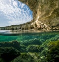 View of the cliffs and sea caves of Cape Greco from under the wa