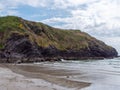 View of the cliffs from the Warren beach. The rocky coast of the south of Ireland. Hills under the sky on a spring day, mountain Royalty Free Stock Photo