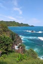 view of the cliffy beach with a blue sea background on the island of Bali