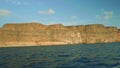 View of cliffy shore of Gran Canaria with small buildings on top