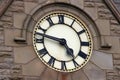 Large clock face in stone wall of building