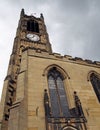 View of the clock tower and building of the historic saint peters parish church in the center of huddersfield against a cloudy sky Royalty Free Stock Photo