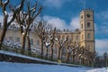 View of the clock tower of the Gatchina Palace from the White Lake. Winter, sunny. On the left is the stone wall of the Royalty Free Stock Photo