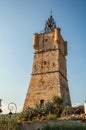 View of the clock tower made of stone on top of the hill with vegetation in Draguignan. Royalty Free Stock Photo