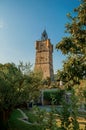 View of the clock tower made of stone on top of the hill with vegetation in Draguignan. Royalty Free Stock Photo