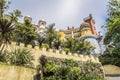 View of the clock tower, wall and palm trees in the Pena National Palace in Sintra town, Portugal Royalty Free Stock Photo