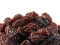 From view and close up of a pile of raisins isolated on white background. A raisin is a dried grape.