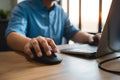 view Closeup male hand using wireless keyboard, mouse, office desk Royalty Free Stock Photo