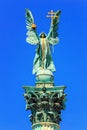 View closeup of the top of the column with statue Archangel Gabriel, who holds the Hungarian Holy Crown, part of the Millennium Mo