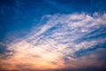 View of cloudy blue sky with orange rays of light during sunset. Royalty Free Stock Photo