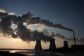 View of coal powerplant against sun and huge fumes Royalty Free Stock Photo