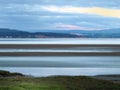 View of the coast at grange over sands in cumbria at twilight with grass covered wetland in the foregrounds and the lake district