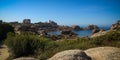 View on the coast of pink granite and the lighthouse of Men Ruz Royalty Free Stock Photo
